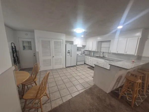 a kitchen with stainless steel appliances a refrigerator sink and cabinets