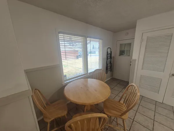 a view of a dining room with furniture and window
