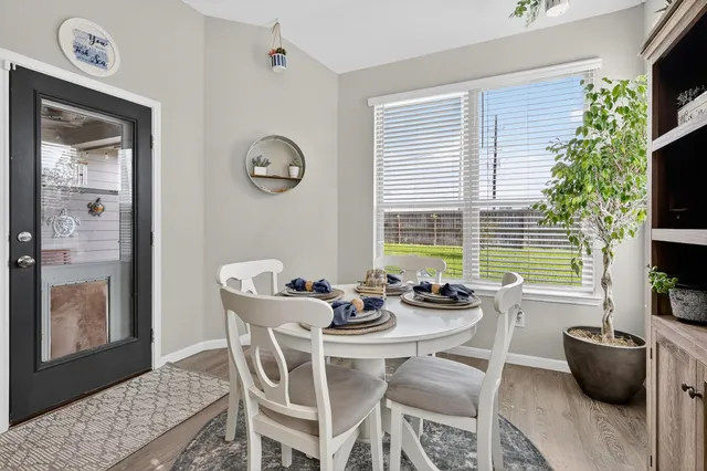 a dining room with furniture and window
