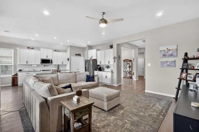 a living room with furniture and a kitchen view