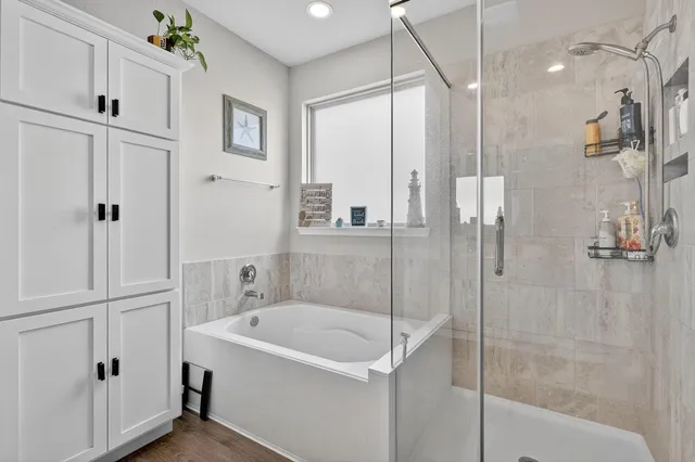 a bathroom with a bathtub and a shower