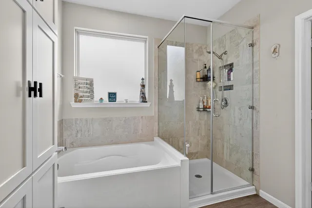 a white bath tub sitting next to a shower