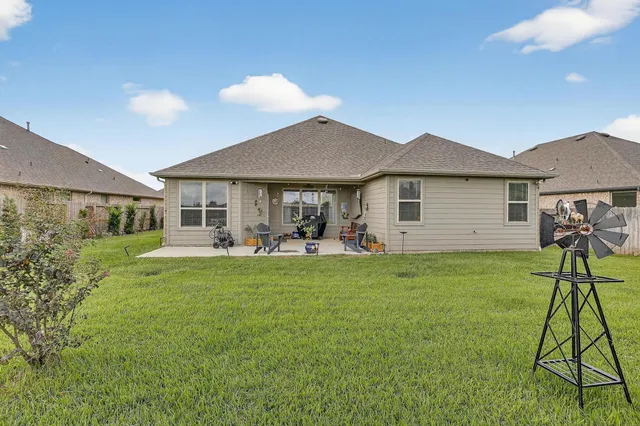 a front view of a house with a yard and porch