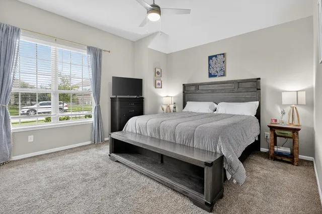 a spacious bedroom with a bed and a cabinets