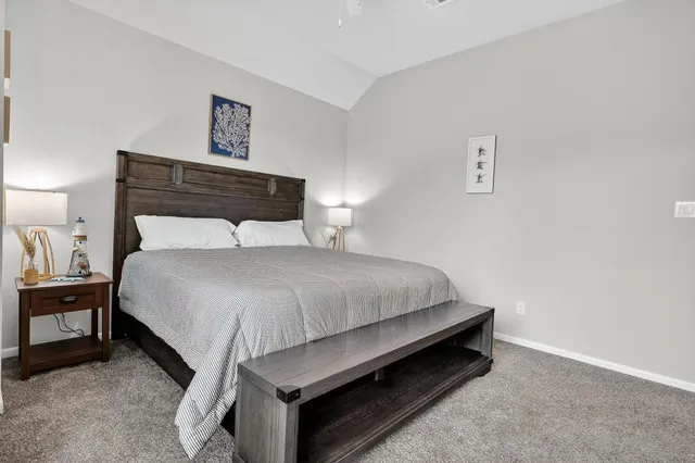 a bedroom with a bed and night stand