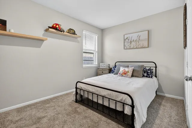 a bedroom with a bed and window