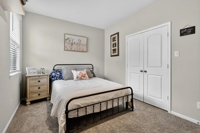 a bedroom with a bed and a night stand