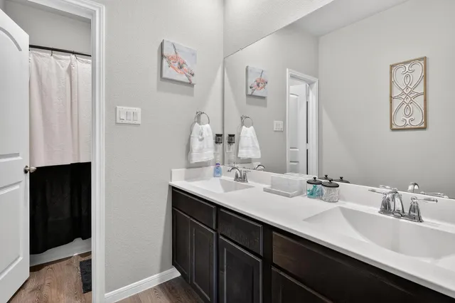 a bathroom with a double vanity sink and a mirror