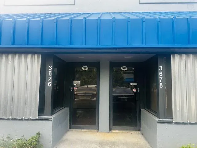 a kitchen with granite countertop wooden cabinets and a refrigerator