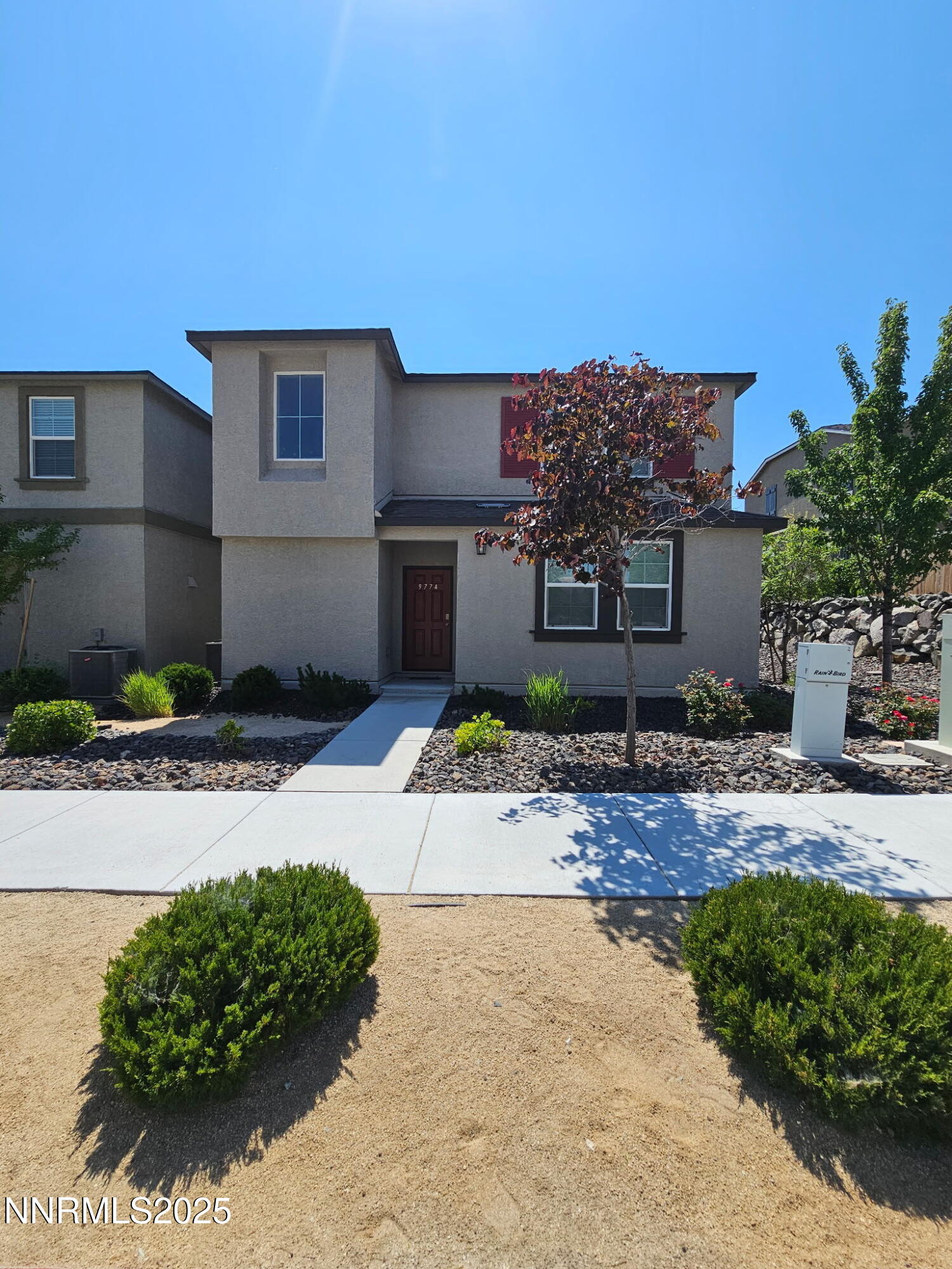 9774 Silver Dollar Lane Reno, NV 89506 - Photo 2 of 26 a front view of a house with a yard and a garage