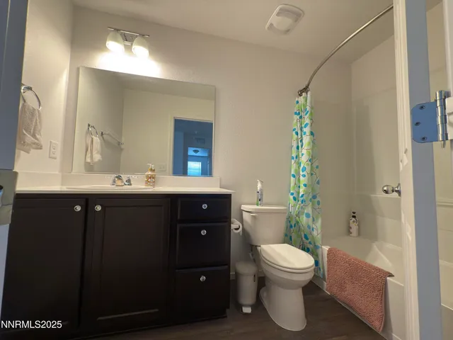 a bathroom with a double vanity sink toilet mirror and bathtub