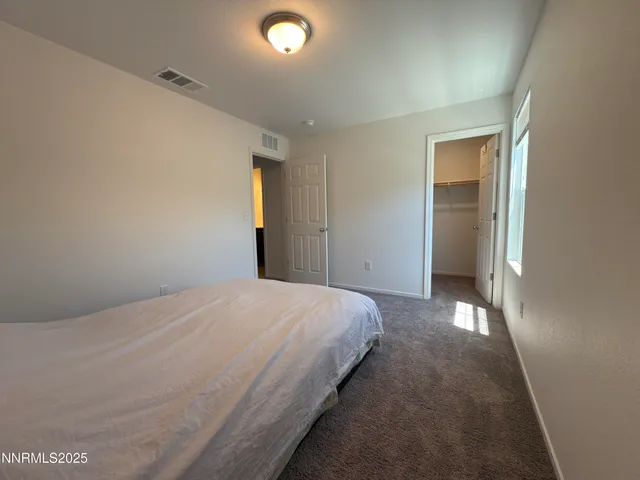 a bedroom with a bed and closet