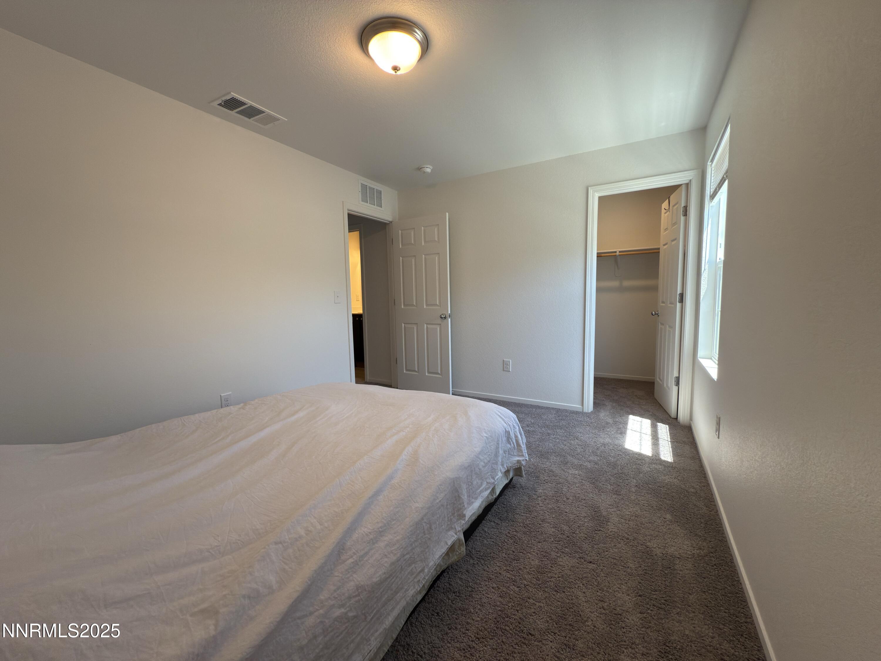 9774 Silver Dollar Lane Reno, NV 89506 - Photo 24 of 26 a bedroom with a bed and closet