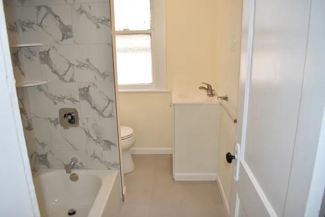 a bathroom with a bathtub and shower