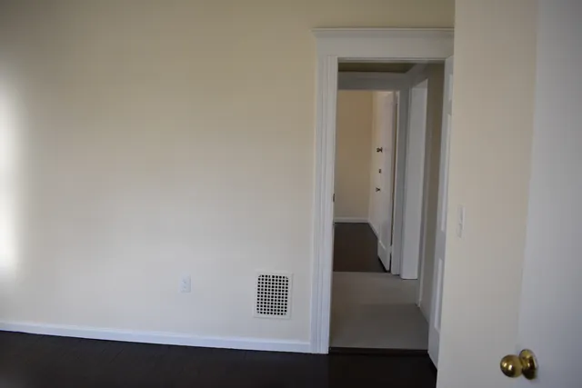 a view of hallway with windows and chandelier fan