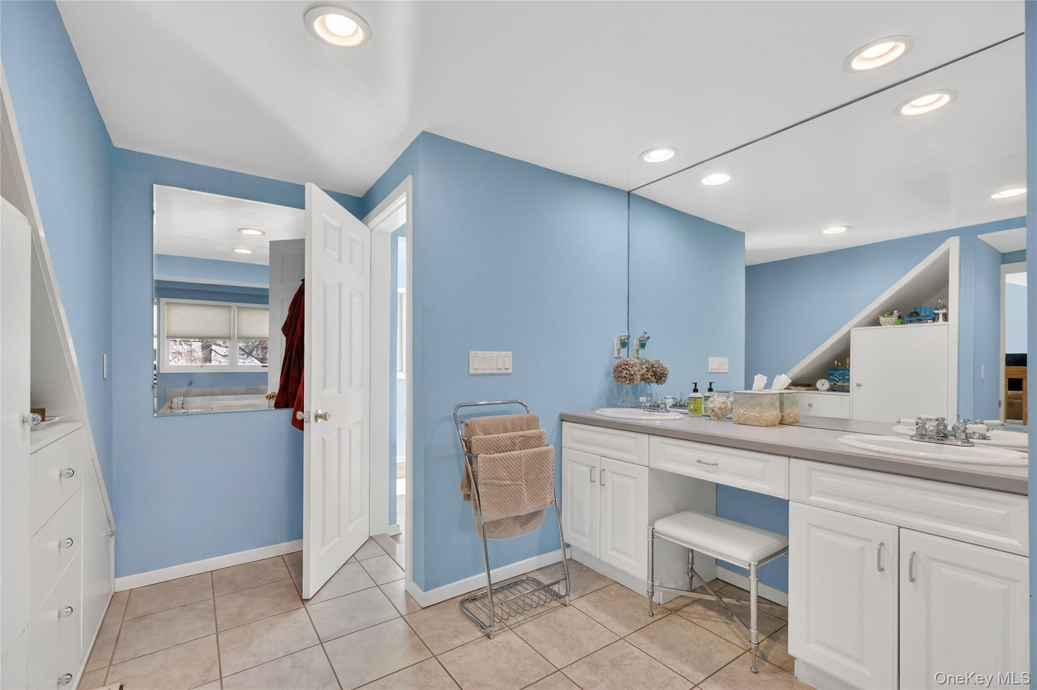3 Lakeside Road Mahopac, NY 10541 - Photo 32 of 49 There is a double vanity with a makeup counter. There is also a linen closet in the primary bathroom.
