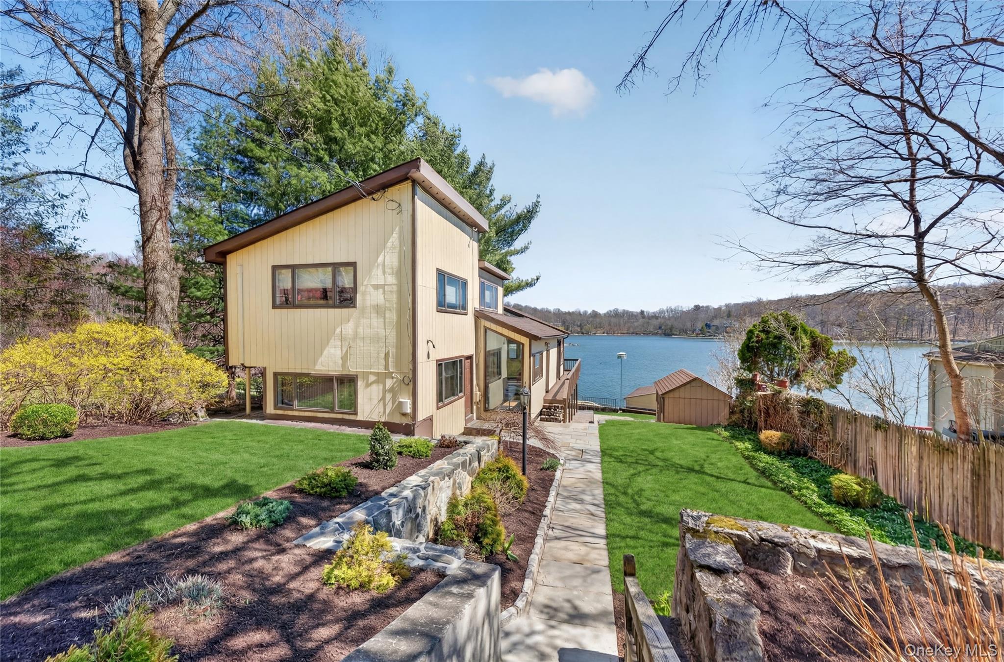 3 Lakeside Road Mahopac, NY 10541 - Photo 4 of 49 The expansive lawn area is professionally landscaped with several garden beds.