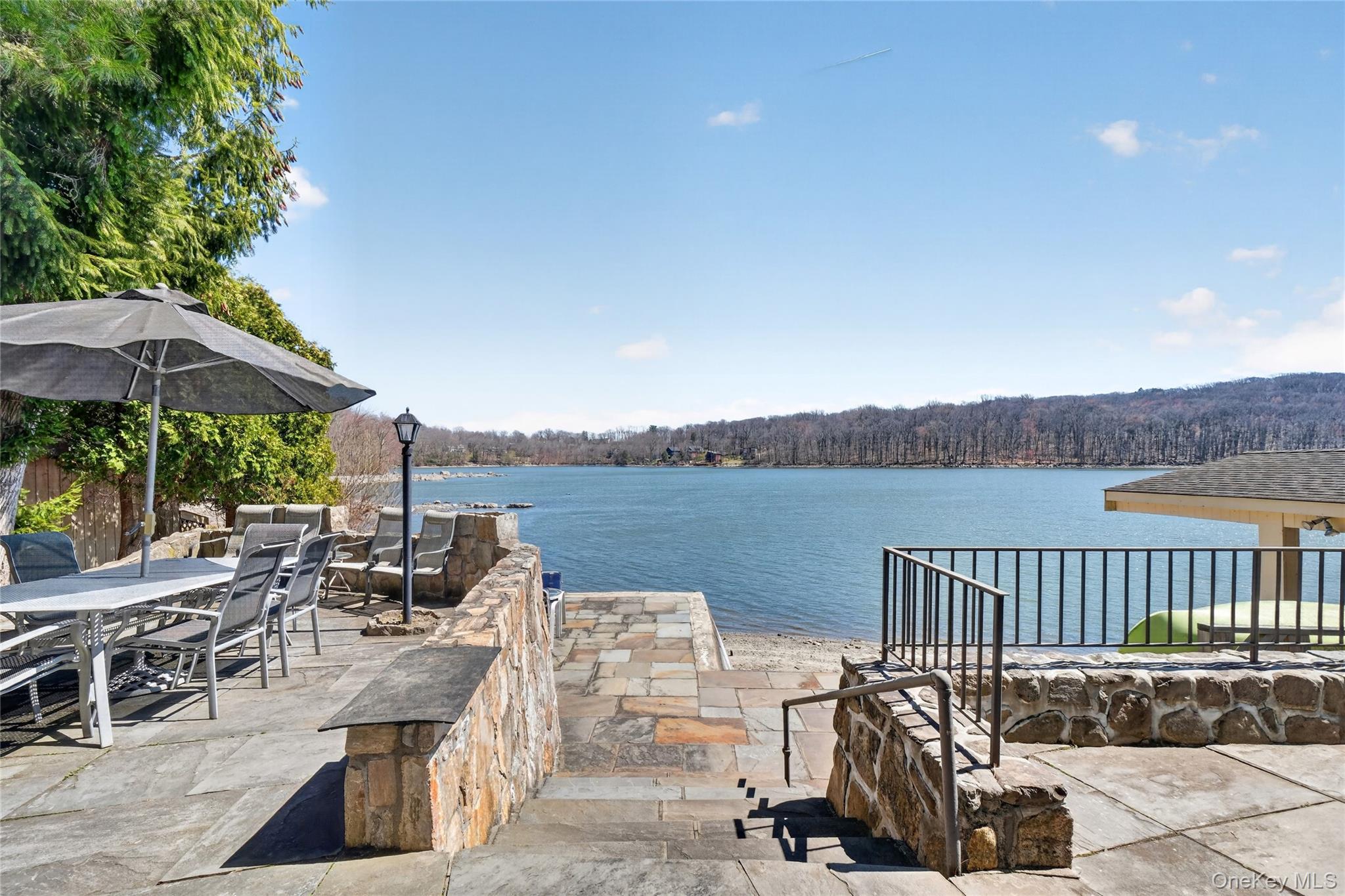 3 Lakeside Road Mahopac, NY 10541 - Photo 7 of 49 Stone walls frame the expansive stone patio overlooking the lake.