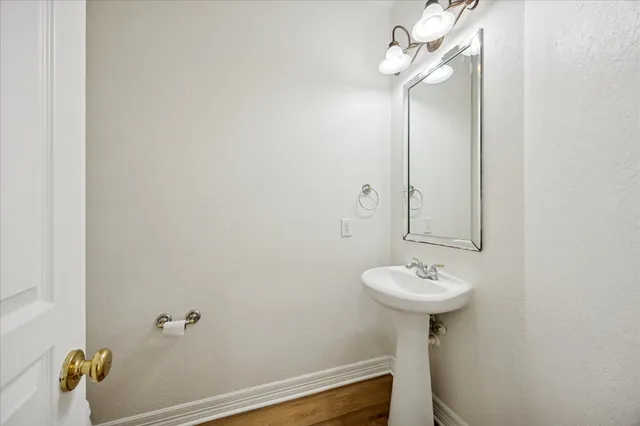a bathroom with a sink a mirror and a toilet
