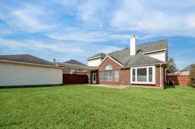 a front view of a house with a garden and yard