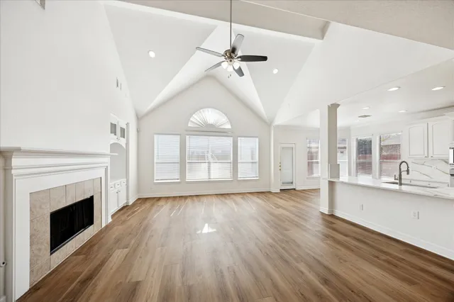a view of an empty room with a fireplace and a window