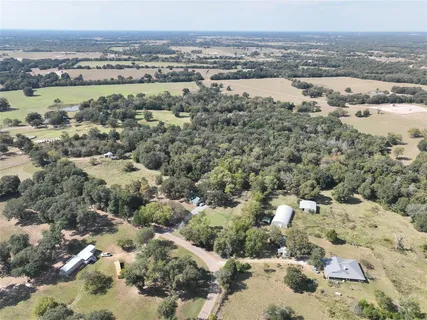 an aerial view of house with yard and mountain view in back