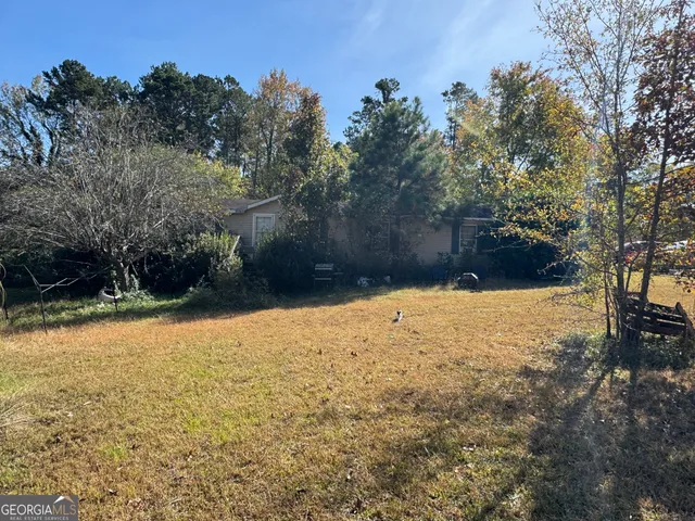 a backyard of a house with lots of green space