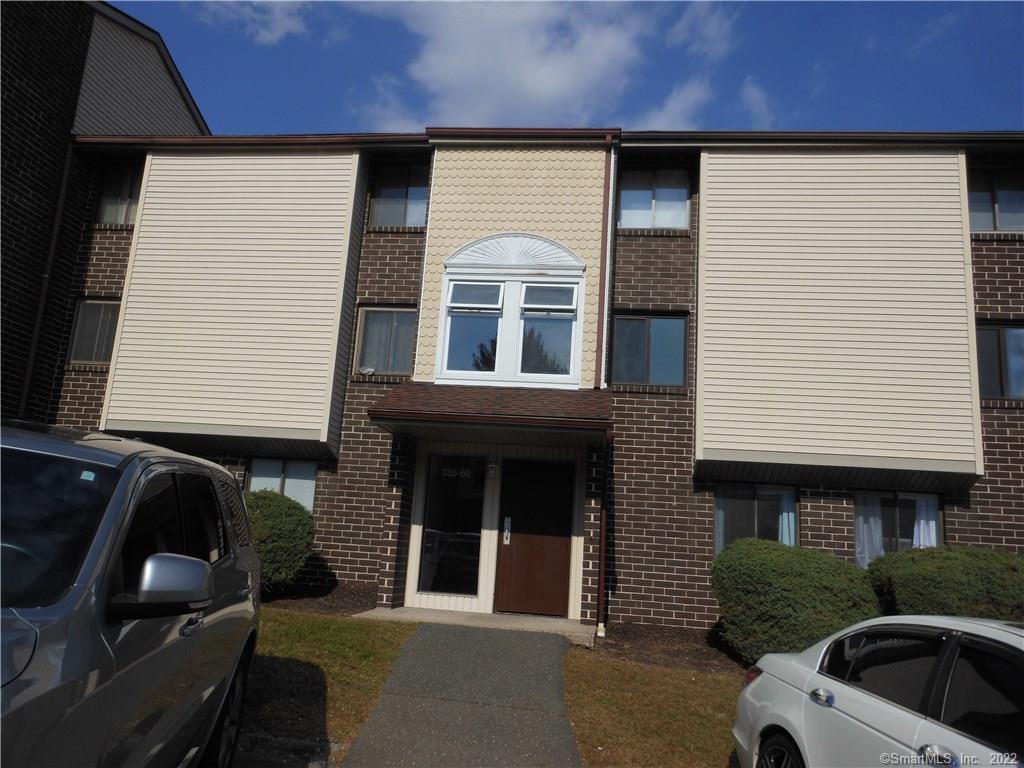7 Padanaram Road, Unit C58 Danbury, CT 06811 - Photo 1 of 17 a front view of a house with parking space