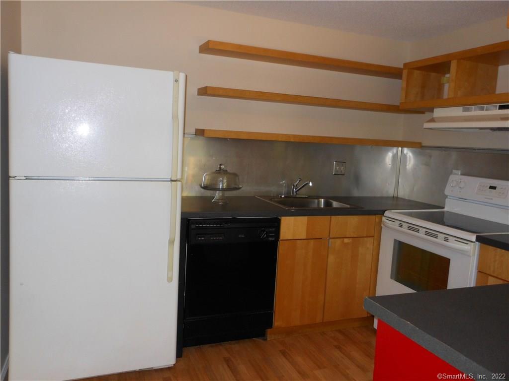 7 Padanaram Road, Unit C58 Danbury, CT 06811 - Photo 13 of 17 a kitchen with stainless steel appliances a refrigerator and a stove
