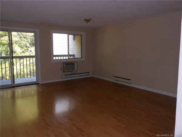 a view of wooden floor and windows in a room