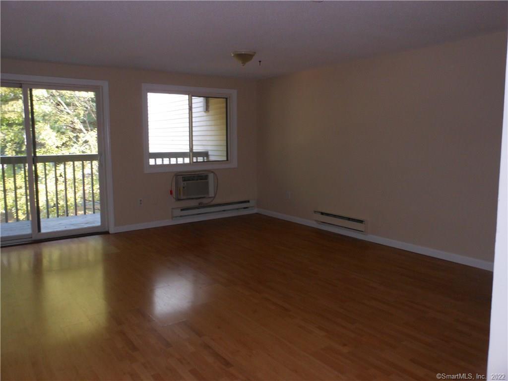 7 Padanaram Road, Unit C58 Danbury, CT 06811 - Photo 3 of 17 a view of wooden floor and windows in a room