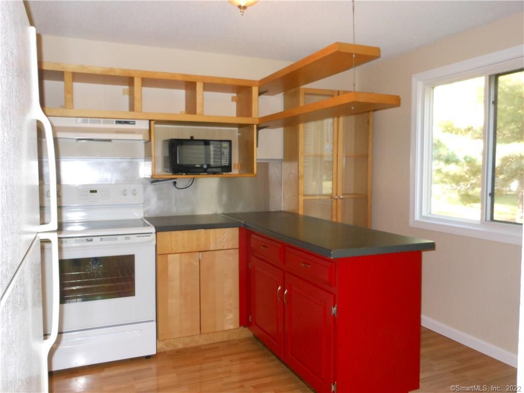 7 Padanaram Road, Unit C58 Danbury, CT 06811 - Photo 5 of 17 a kitchen with stainless steel appliances granite countertop a stove a sink and a microwave