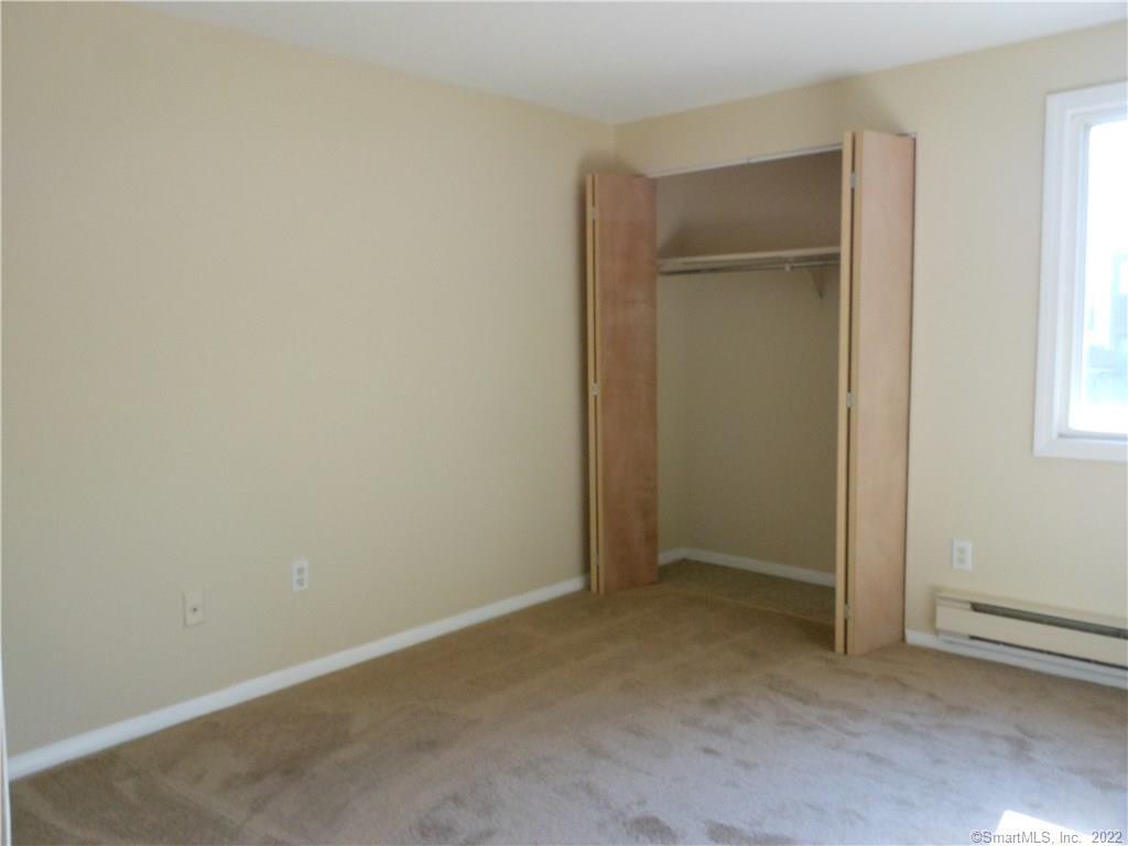 7 Padanaram Road, Unit C58 Danbury, CT 06811 - Photo 10 of 17 an empty room with windows and closet