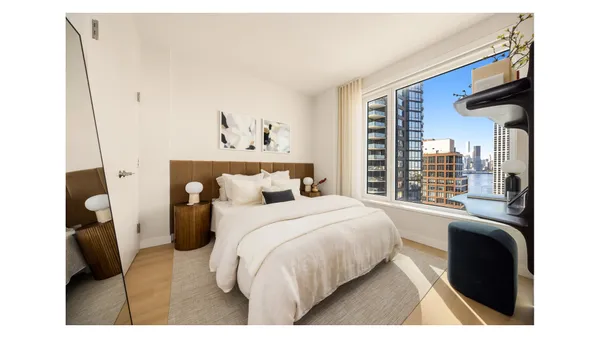 a kitchen with refrigerator and chairs