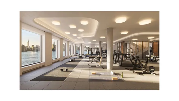 a living room with lots of white furniture and a table