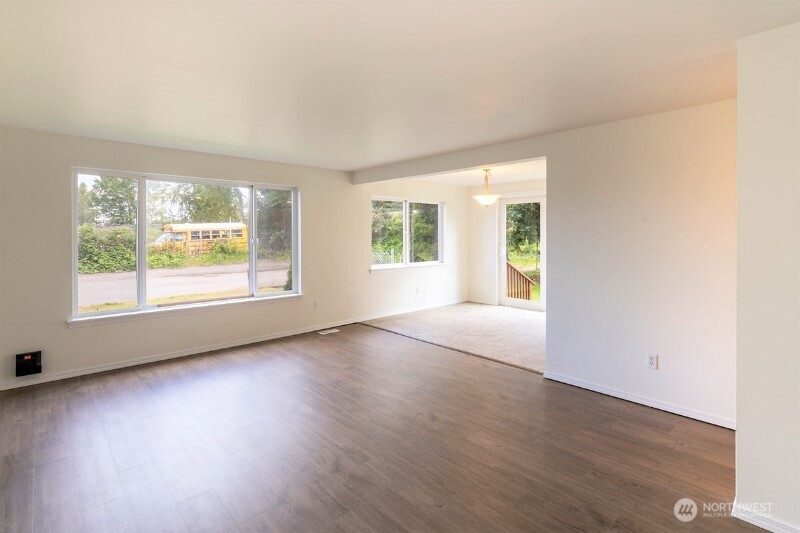 551 South Sullivan Street Seattle, WA 98108 - Photo 14 of 24 an empty room with wooden floor and windows