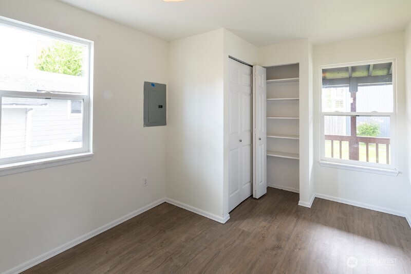 551 South Sullivan Street Seattle, WA 98108 - Photo 20 of 24 an empty room with wooden floor and windows