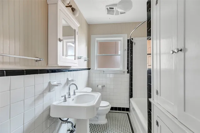a view of a room with wooden floor and ceiling fan