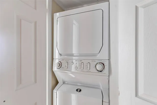 a view of backyard with a table and chairs and potted plants