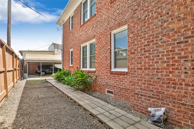 a view of a patio with a table and chairs and potted plants