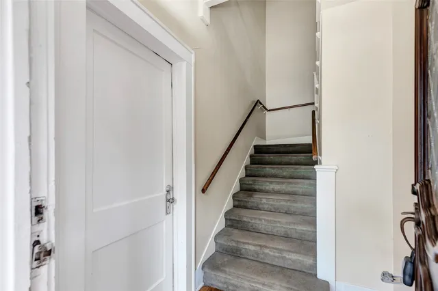a view of an empty room and wooden floor