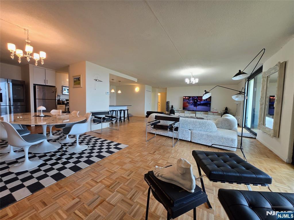 1275 15th Street, Unit PHB Fort Lee, NJ 07024 - Photo 1 of 14 a living room with lots of furniture and a chandelier
