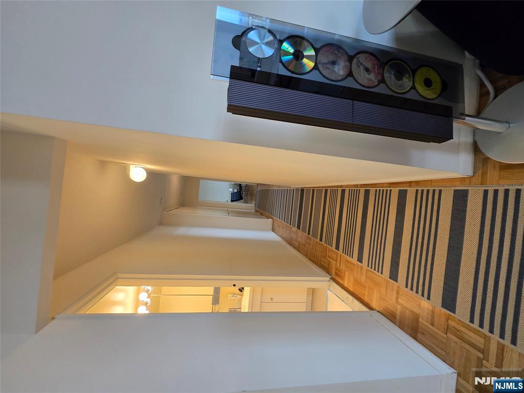 1275 15th Street, Unit PHB Fort Lee, NJ 07024 - Photo 11 of 14 a hallway with painting on the wall and a window
