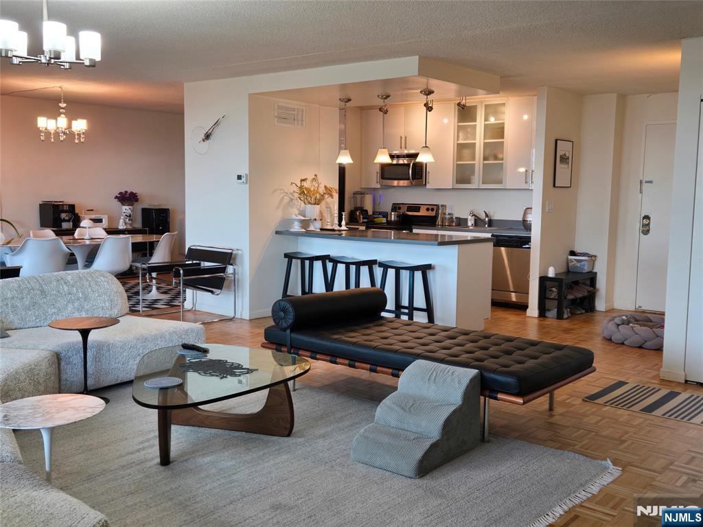 1275 15th Street, Unit PHB Fort Lee, NJ 07024 - Photo 4 of 14 a living room with furniture and a large window