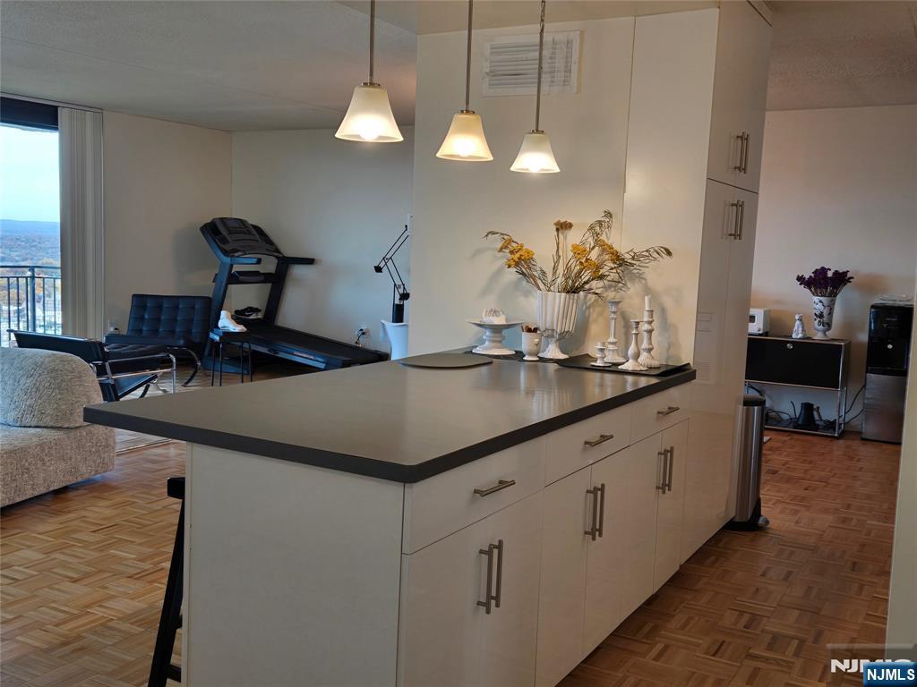 1275 15th Street, Unit PHB Fort Lee, NJ 07024 - Photo 5 of 14 a kitchen with sink cabinets and dining table