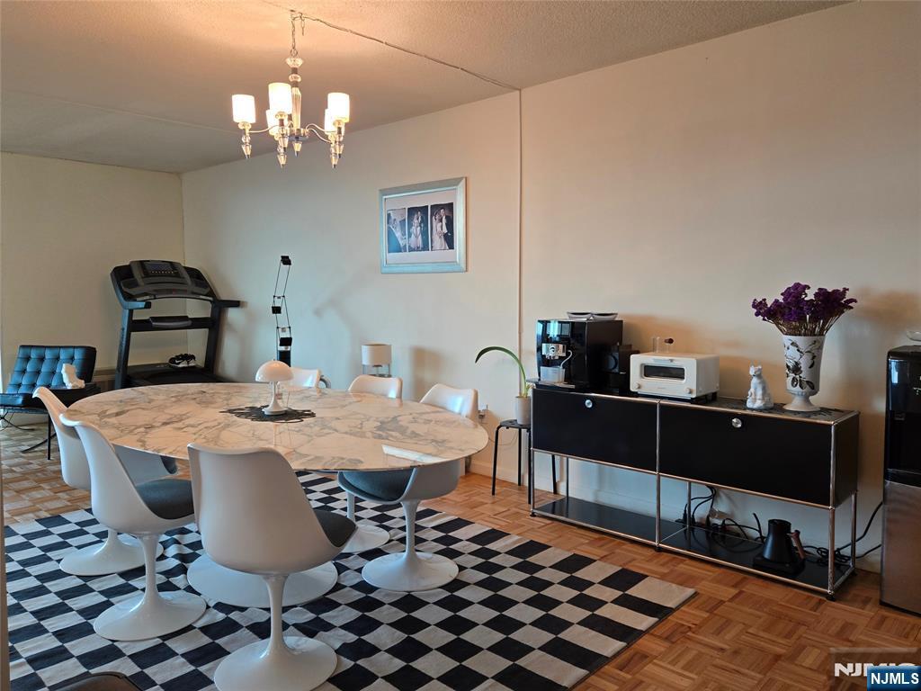 1275 15th Street, Unit PHB Fort Lee, NJ 07024 - Photo 6 of 14 a dining room with a table and chairs