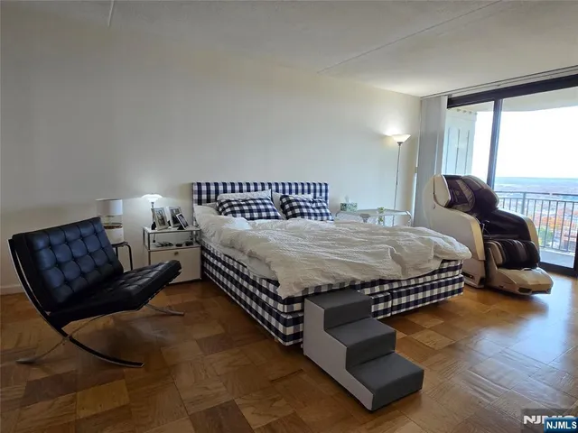 a bedroom with a bed window and couch