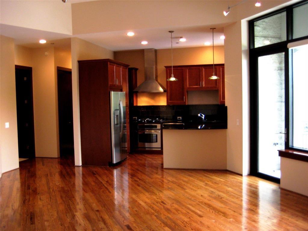 a kitchen with stainless steel appliances granite countertop a refrigerator a sink and a stove top oven