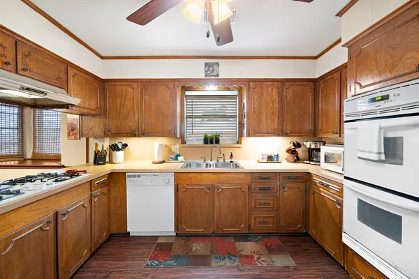 a kitchen with stainless steel appliances granite countertop a stove sink and cabinets
