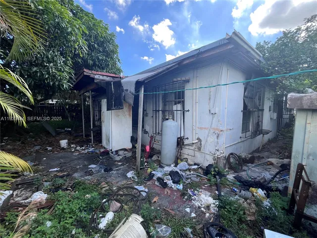 a front view of a house with plants